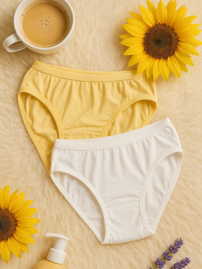 Yellow and white underwear with sunflowers and a cup of coffee on a beige surface