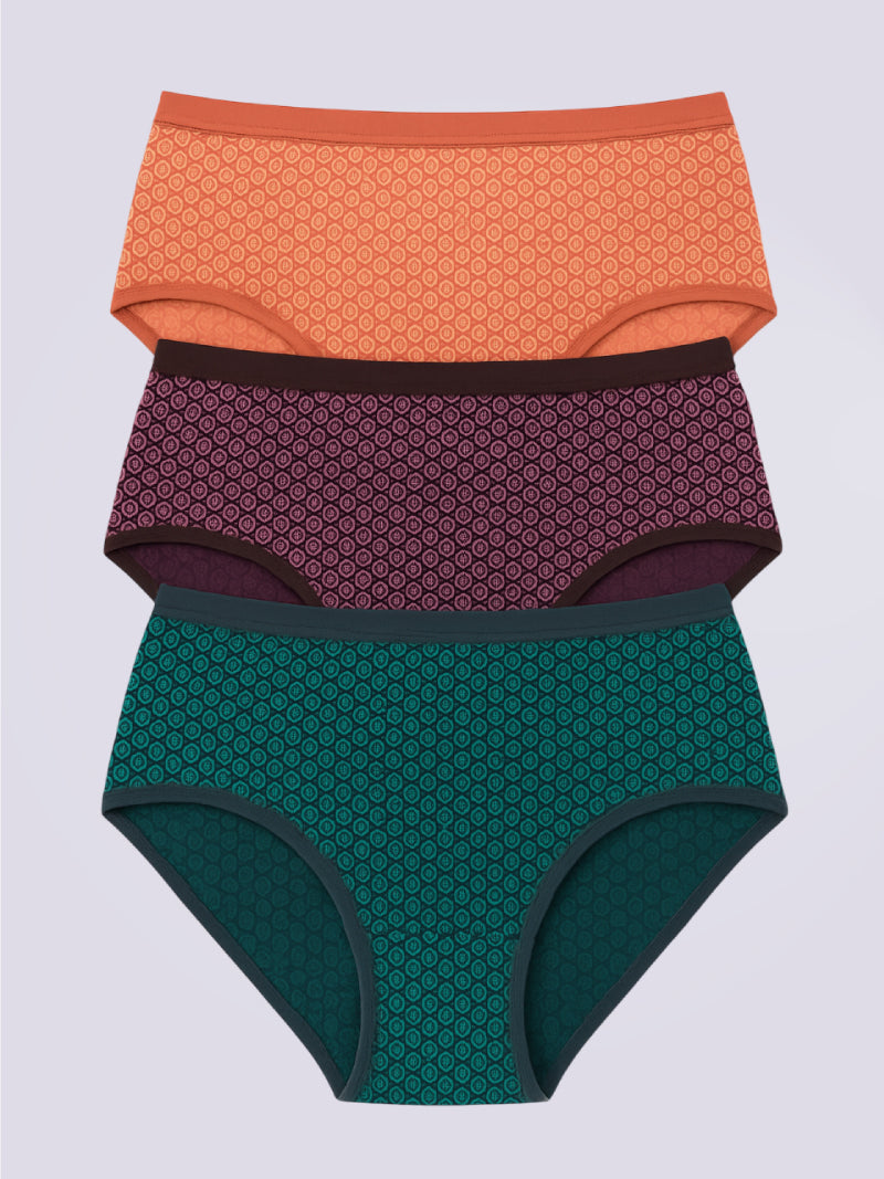Three pairs of patterned underwear in orange, purple, and green on a light gray background.