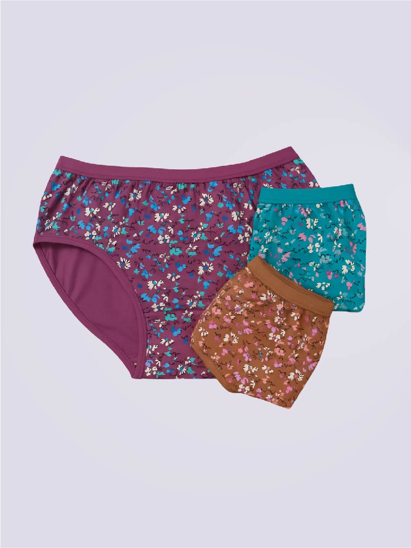 Three pairs of floral-patterned underwear on a light purple background