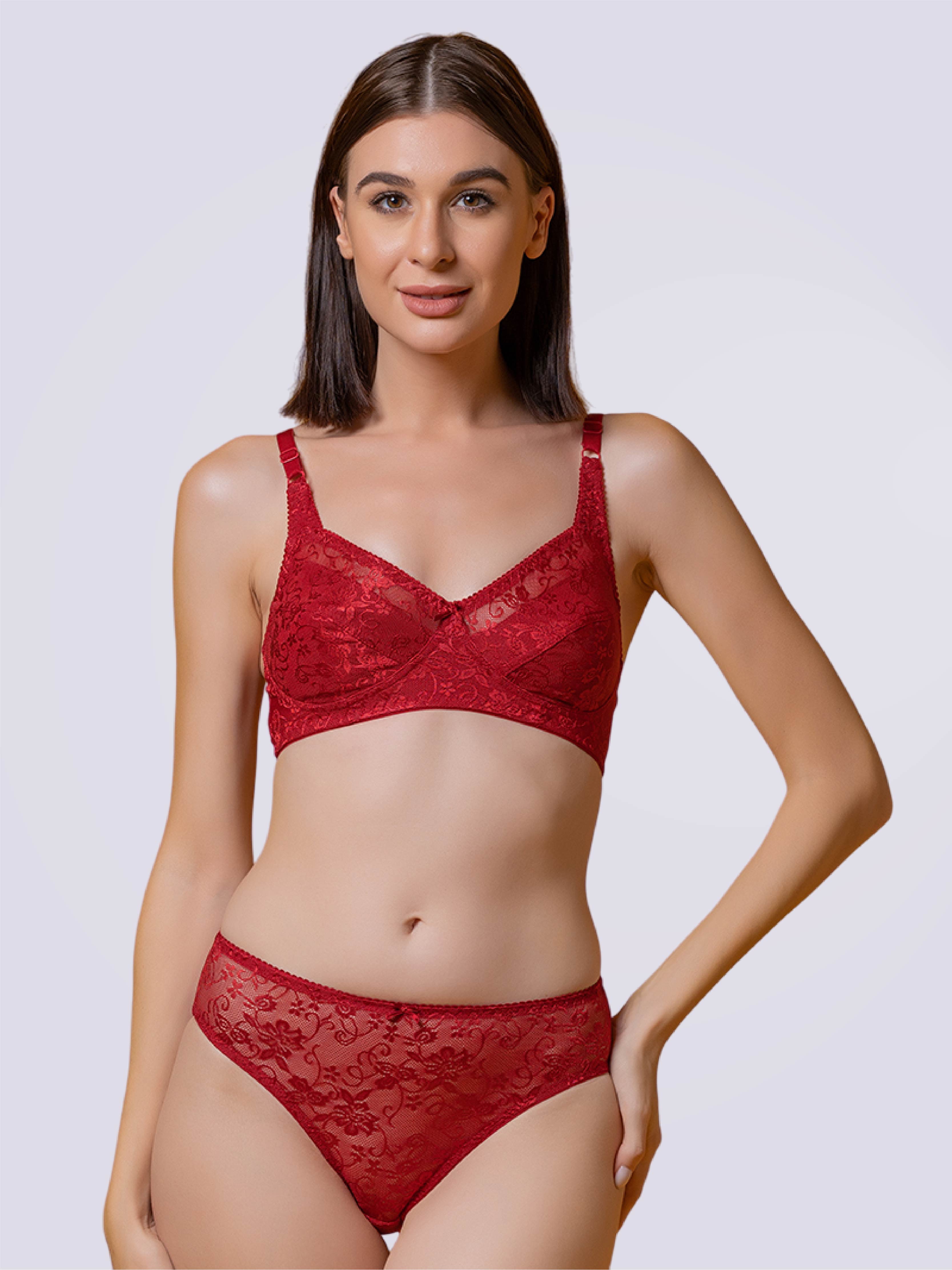 A woman wearing a red lace bra and panties set.