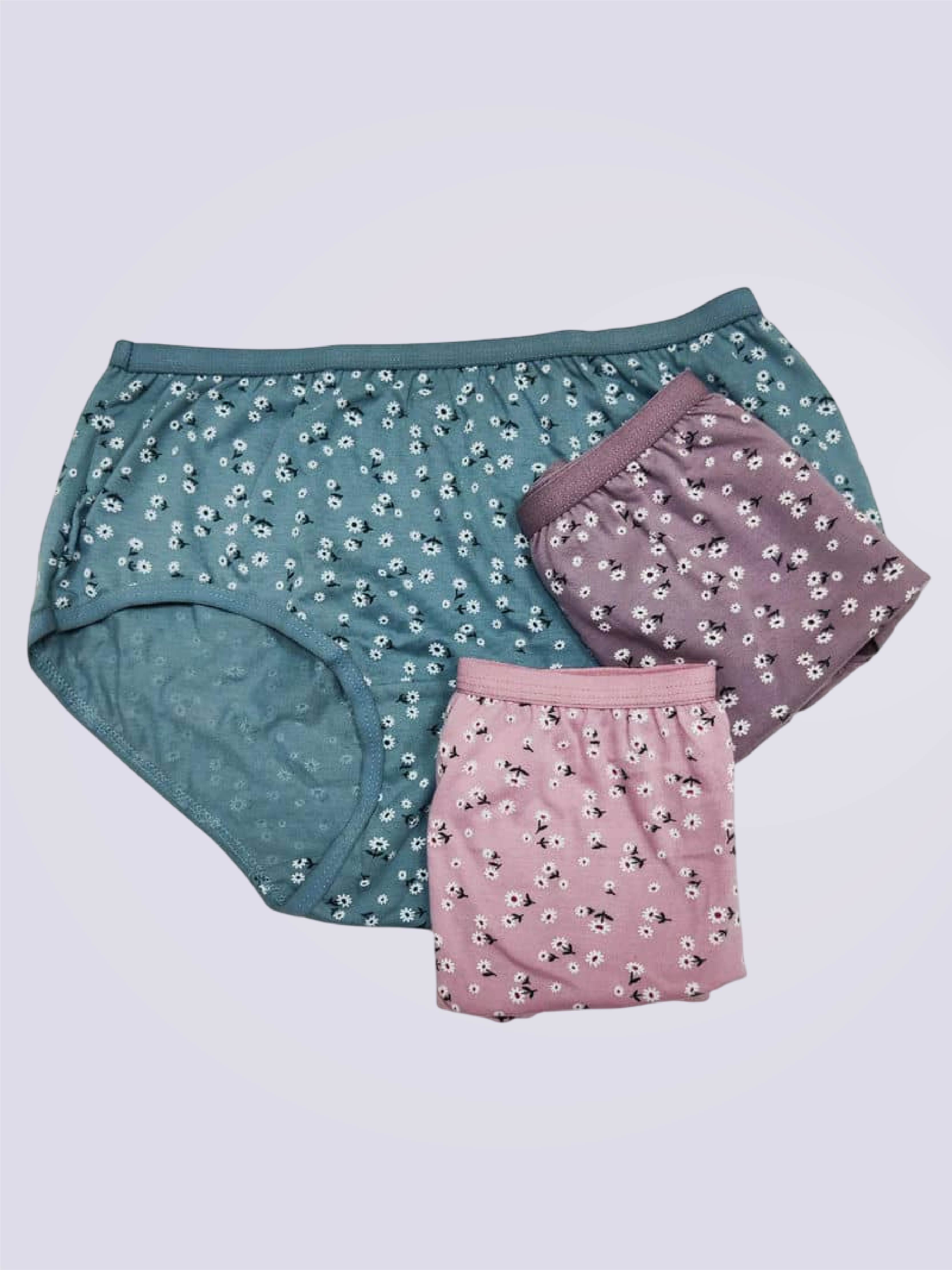 Three pairs of floral underwear on a plain background