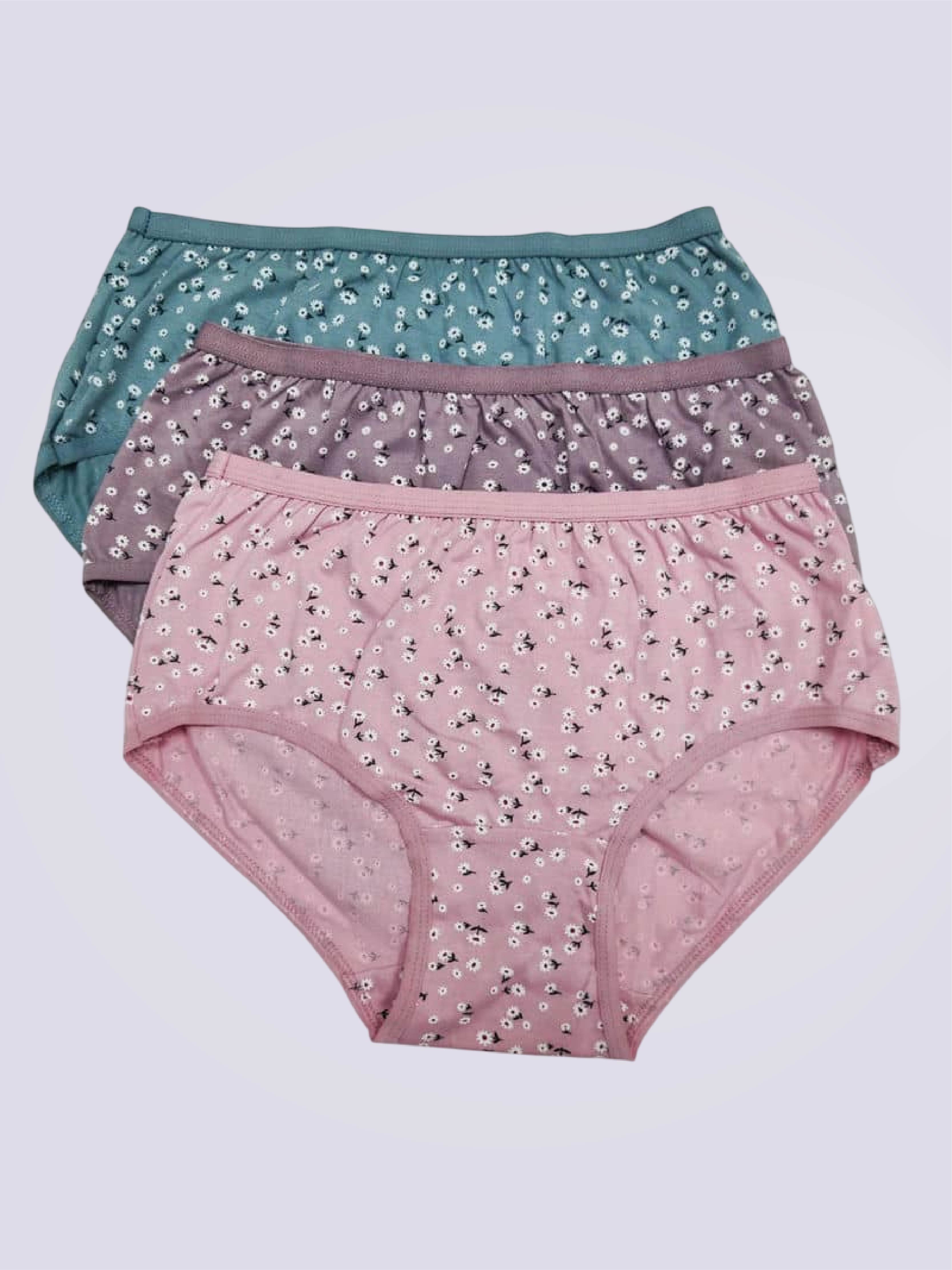 Three pairs of floral underwear on a plain background