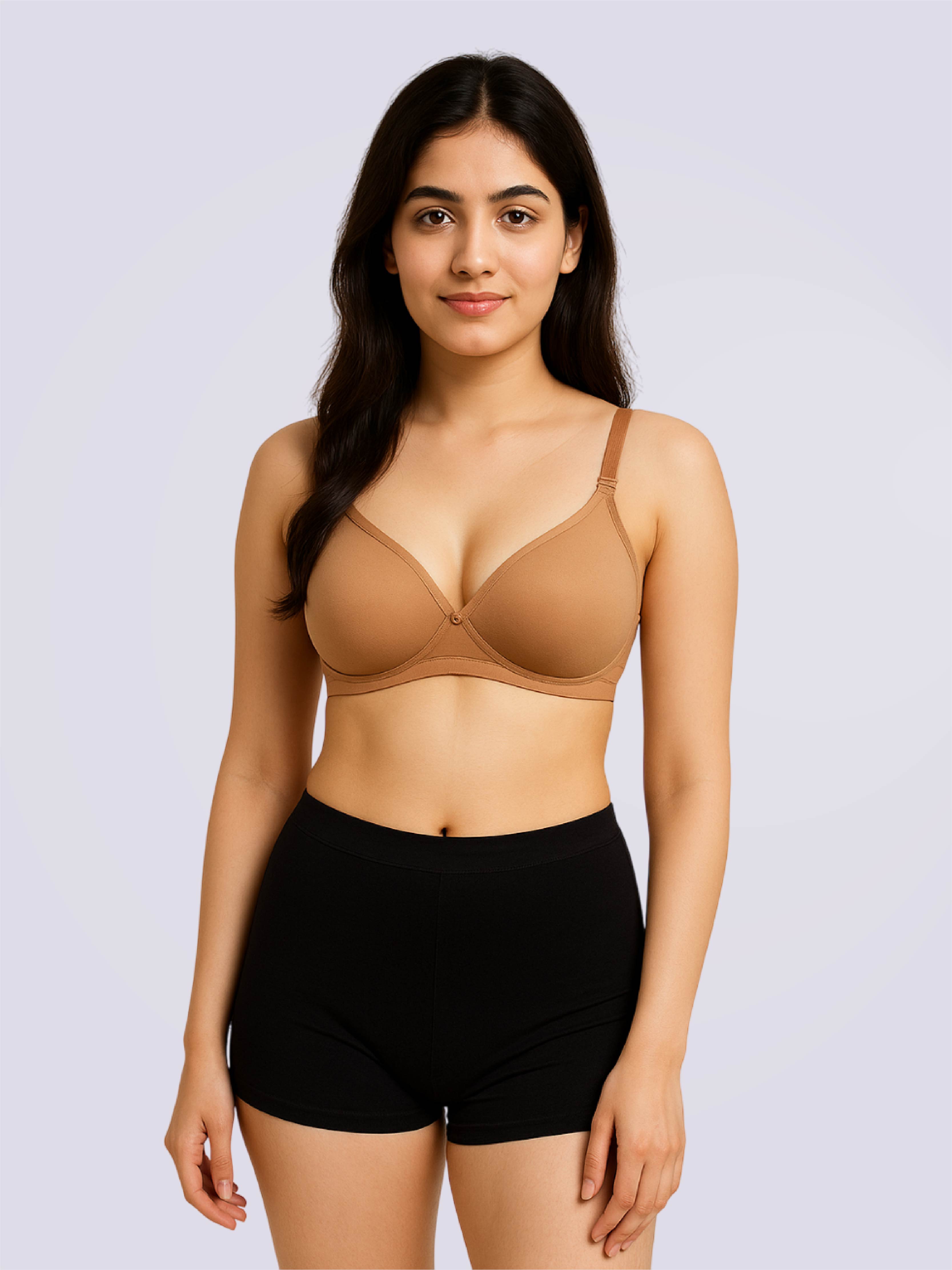 Woman wearing a beige bra and black shorts on a light purple background