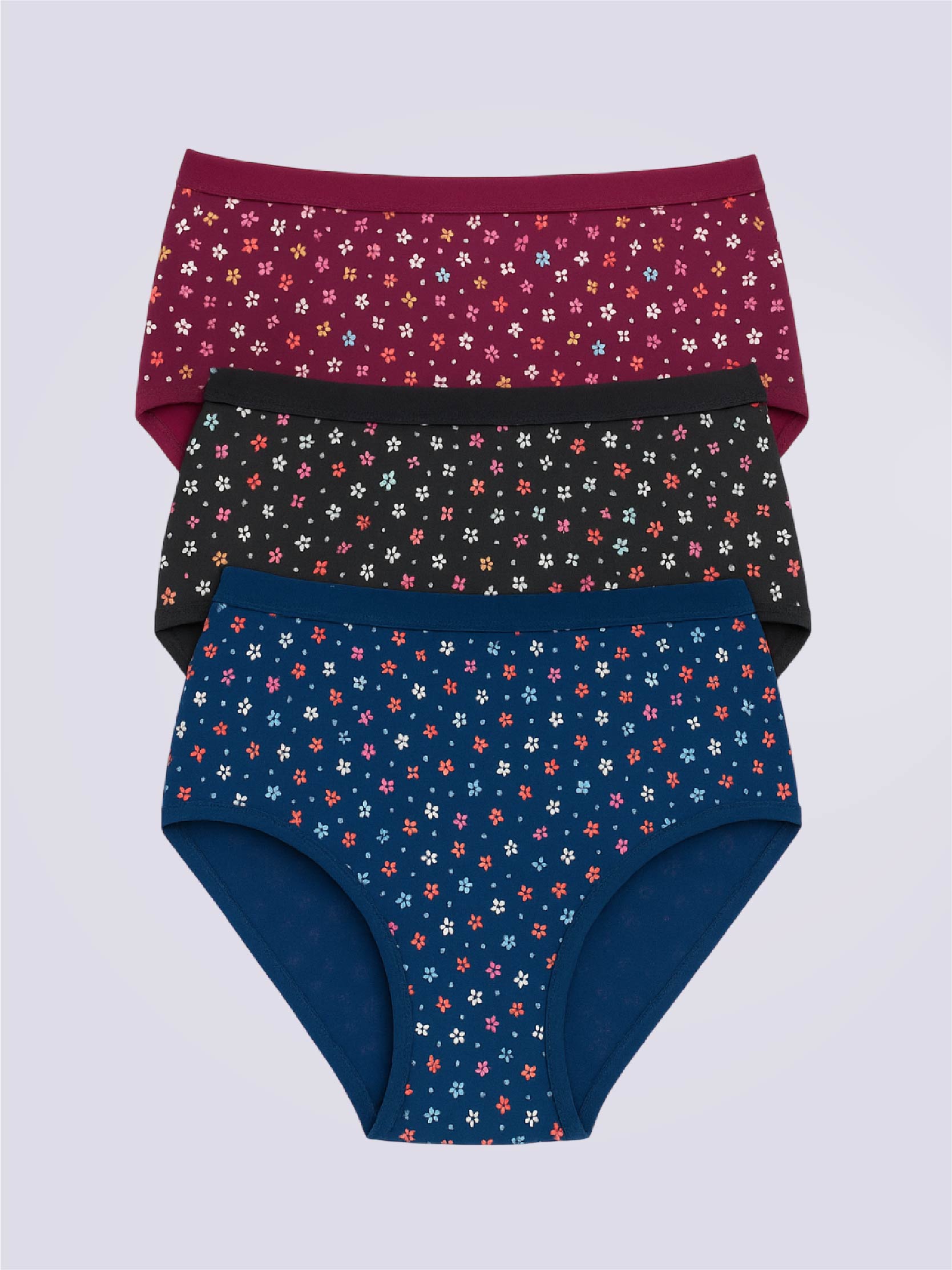 Three pairs of floral-patterned underwear stacked on a light gray background