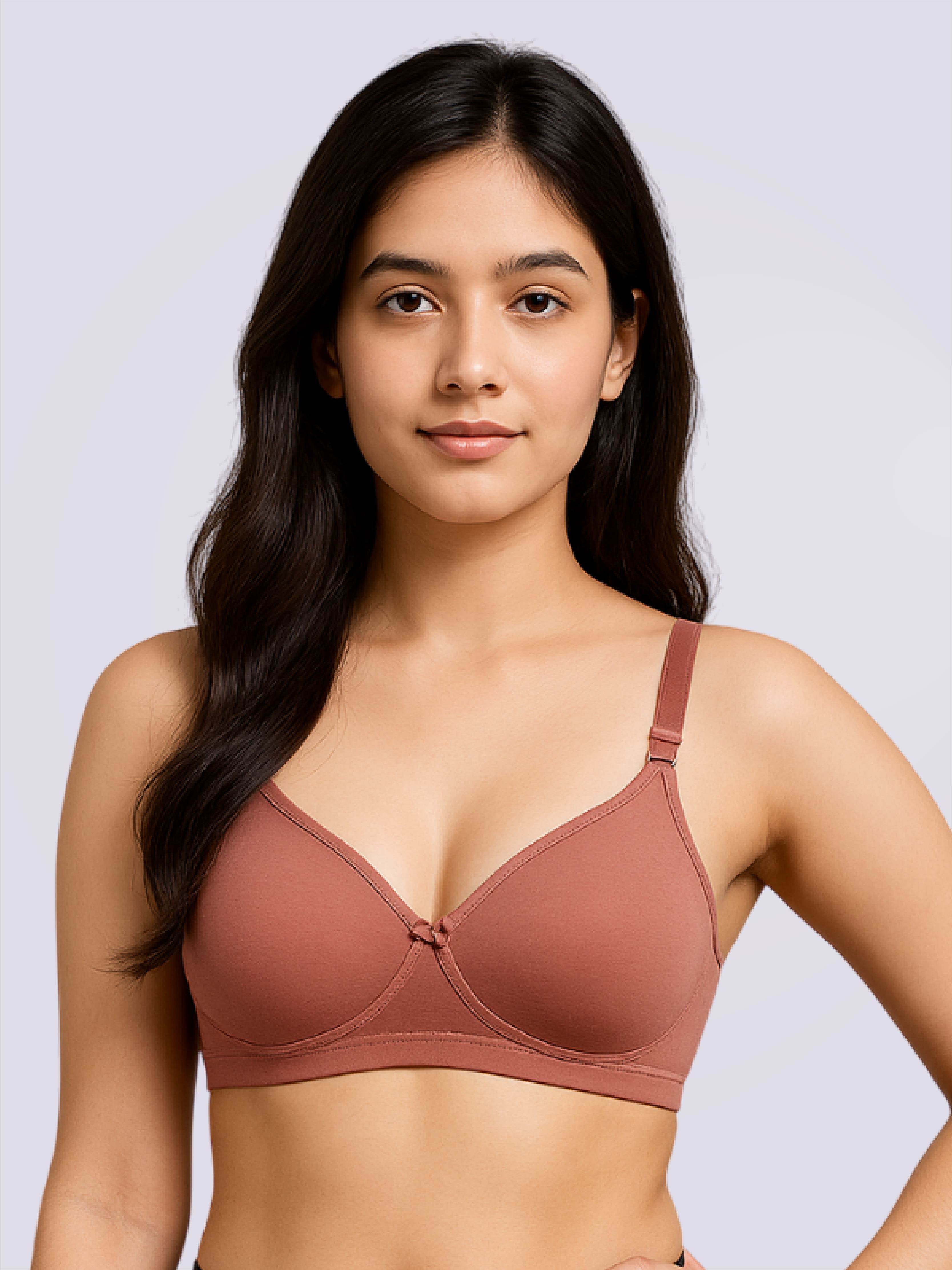Woman wearing a brown bra against a light gray background