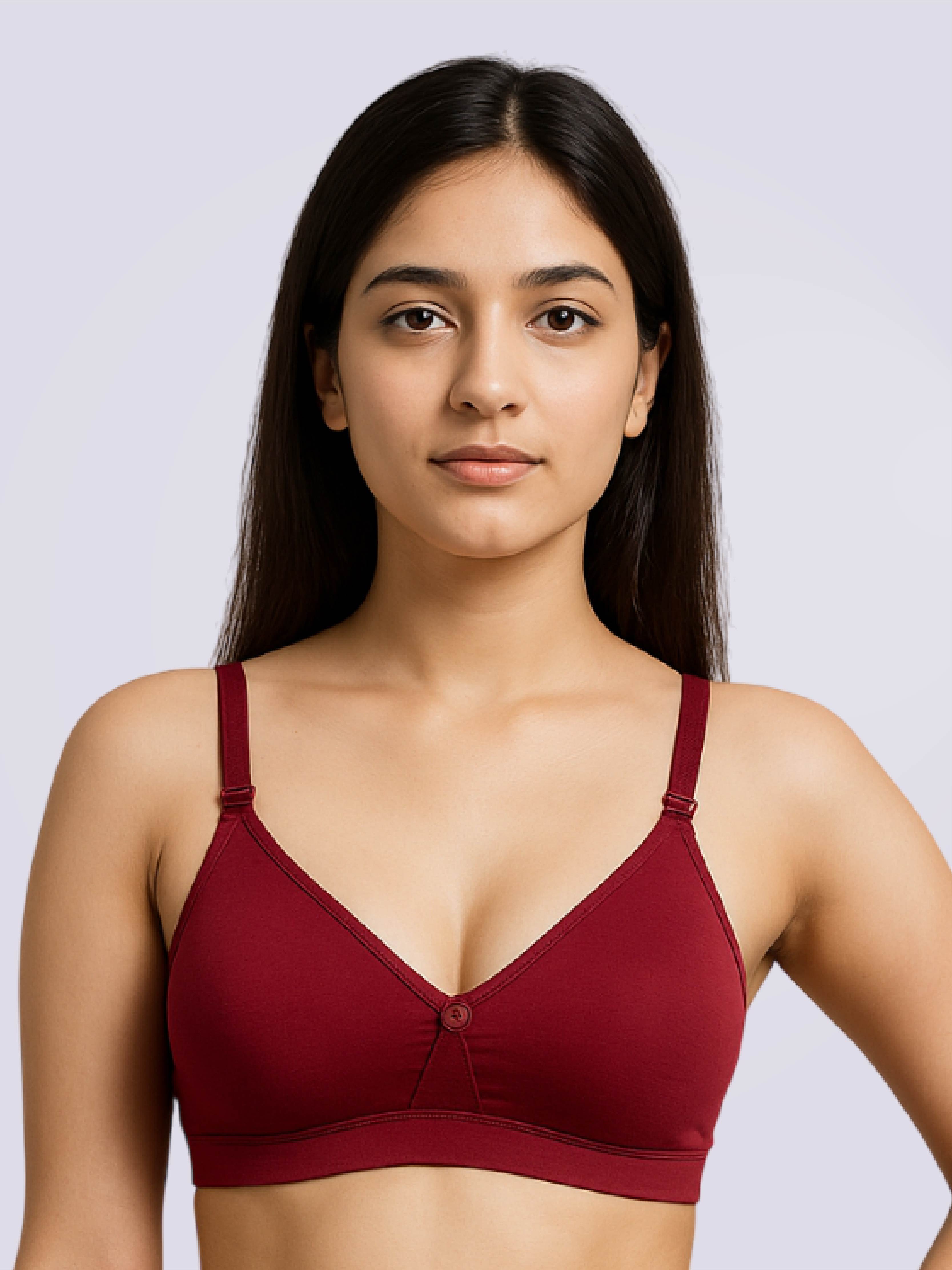 Woman wearing a maroon bralette against a light gray background