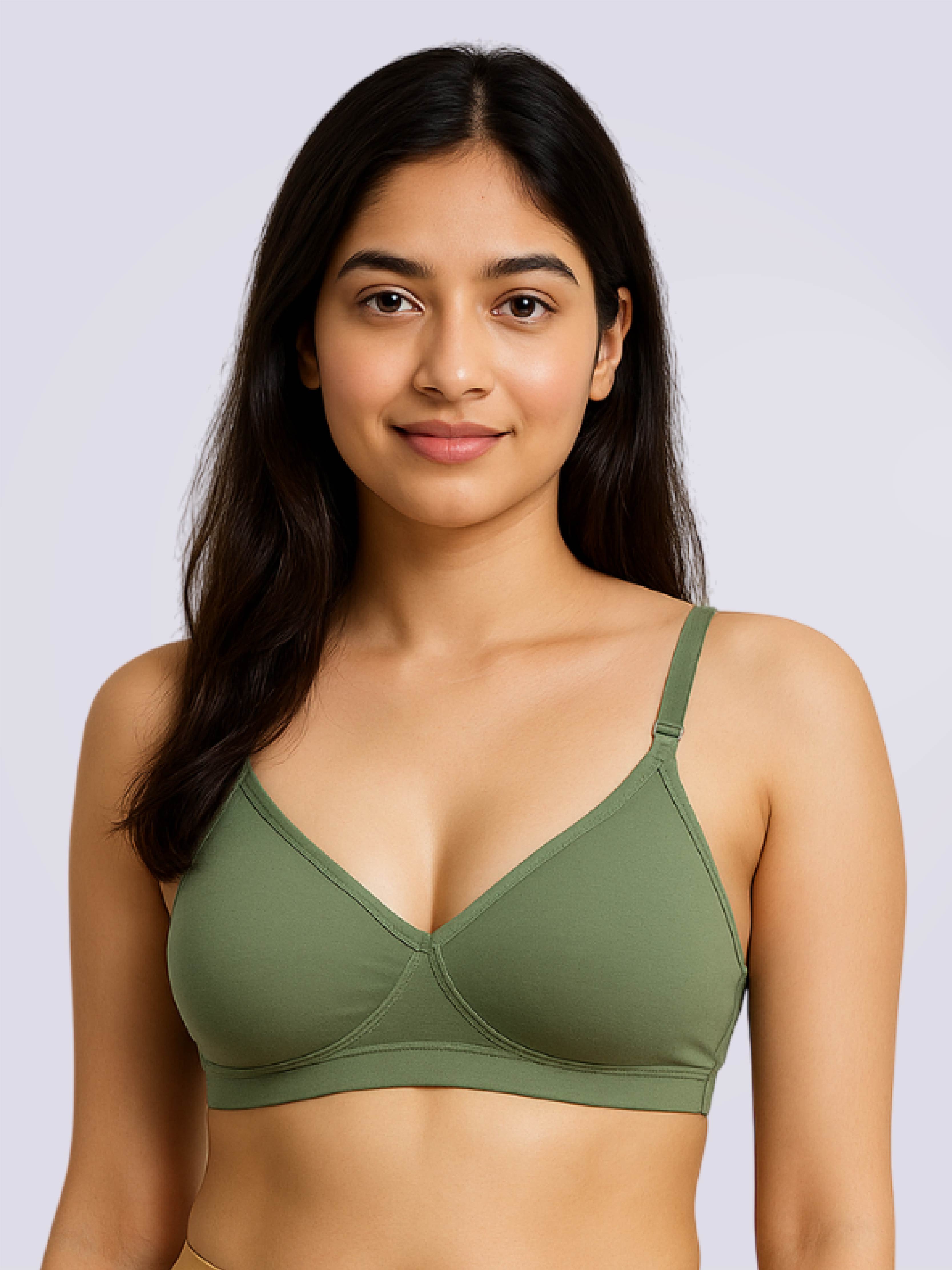 Woman wearing a olive green bra against a plain background