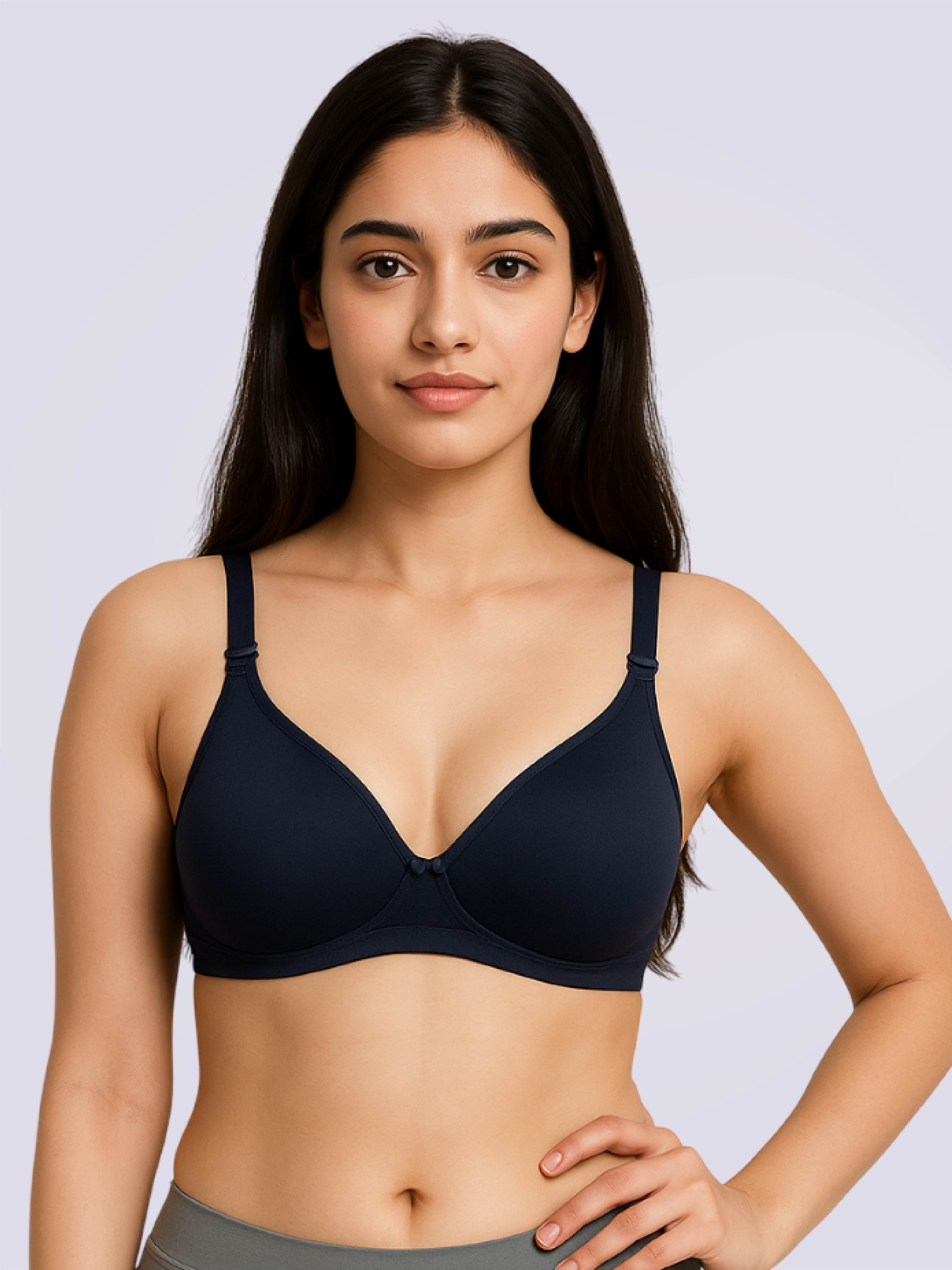 Woman wearing a black bra against a light gray background