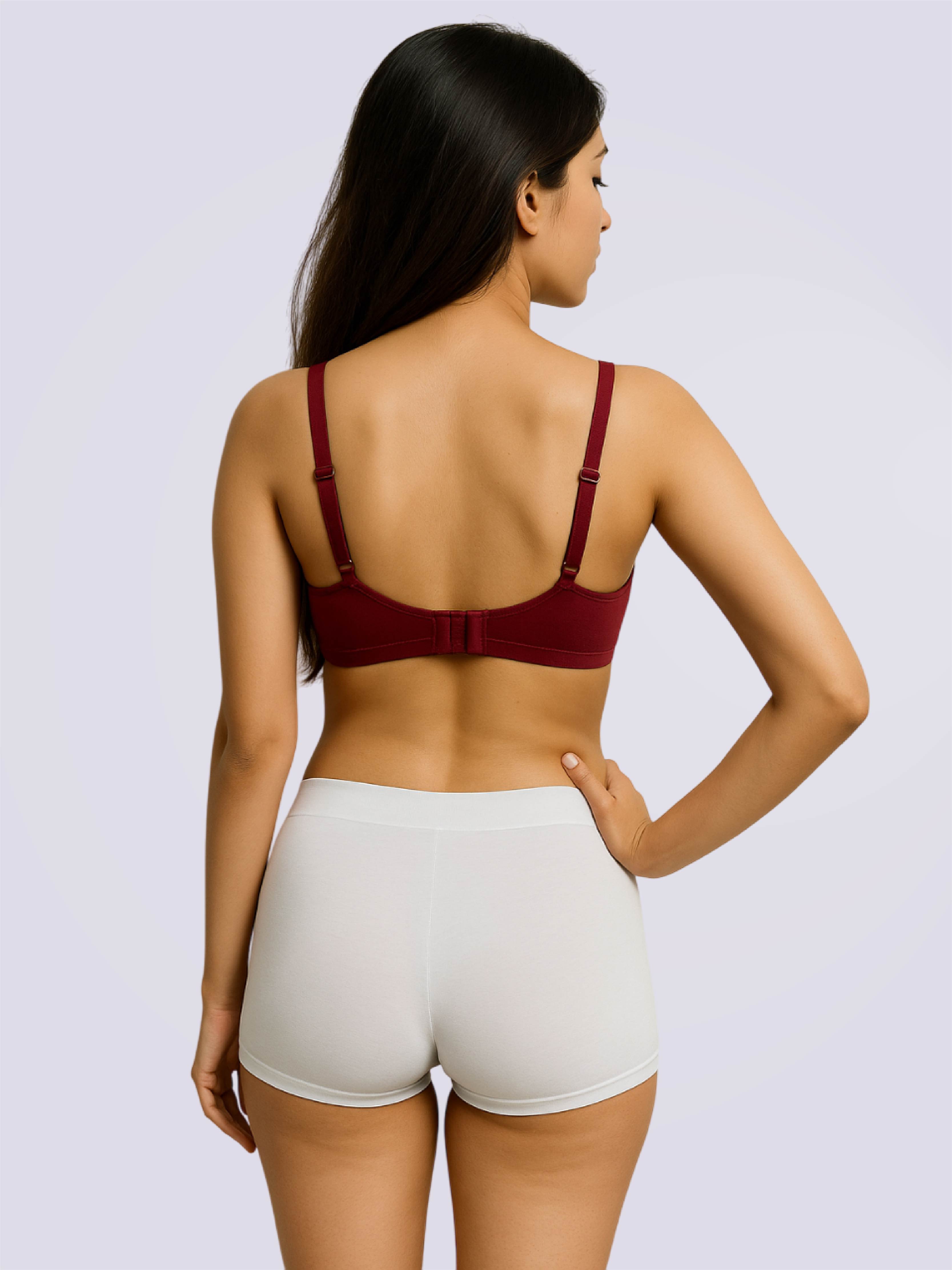 Woman wearing a red bralette and white shorts on a light gray background