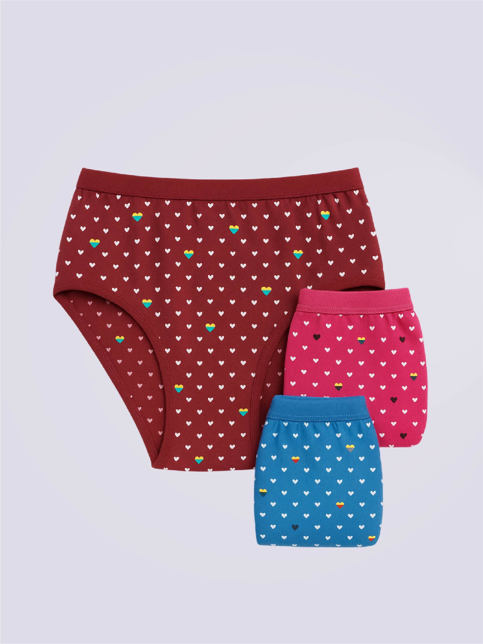 Three pairs of patterned underwear of brown red and blue color on a light gray background