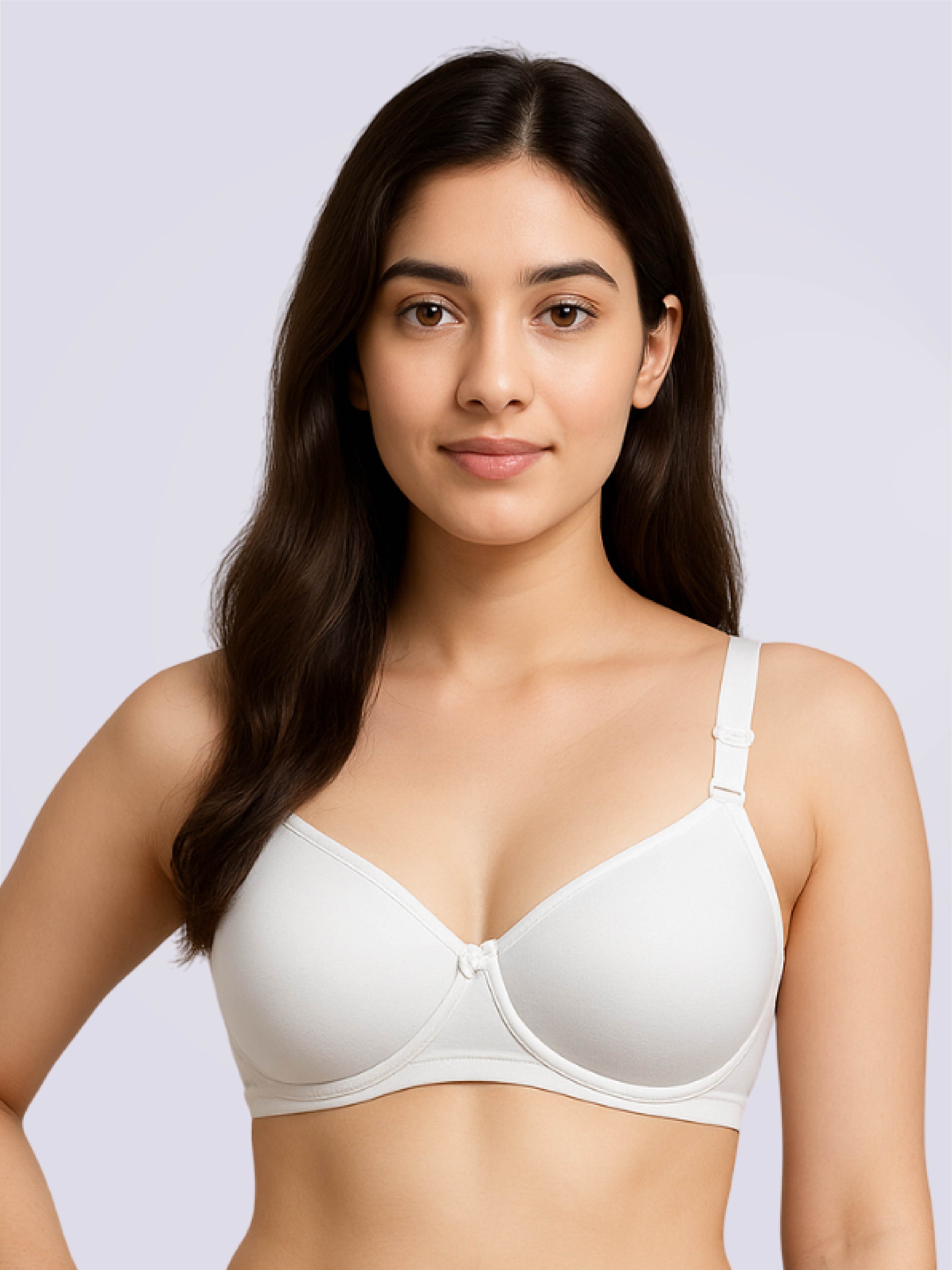 Woman wearing a white bra against a light gray background